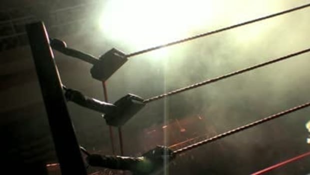 stock-footage-pro-wrestling-ring-ropes-silhouette-smoke-lights