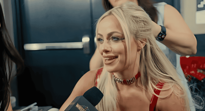 A blonde woman in a red dress is talking to another woman