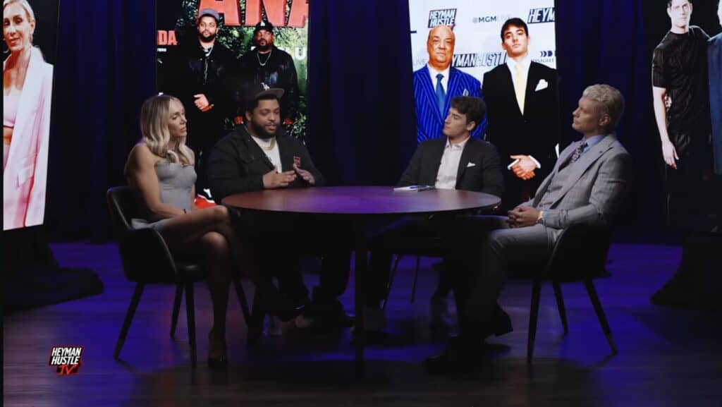 Charlotte Flair, O'Shea Jackson Jr., Jacob Heyman and Cody Rhodes seated at a table on Heyman Hustle TV's The Roundtable